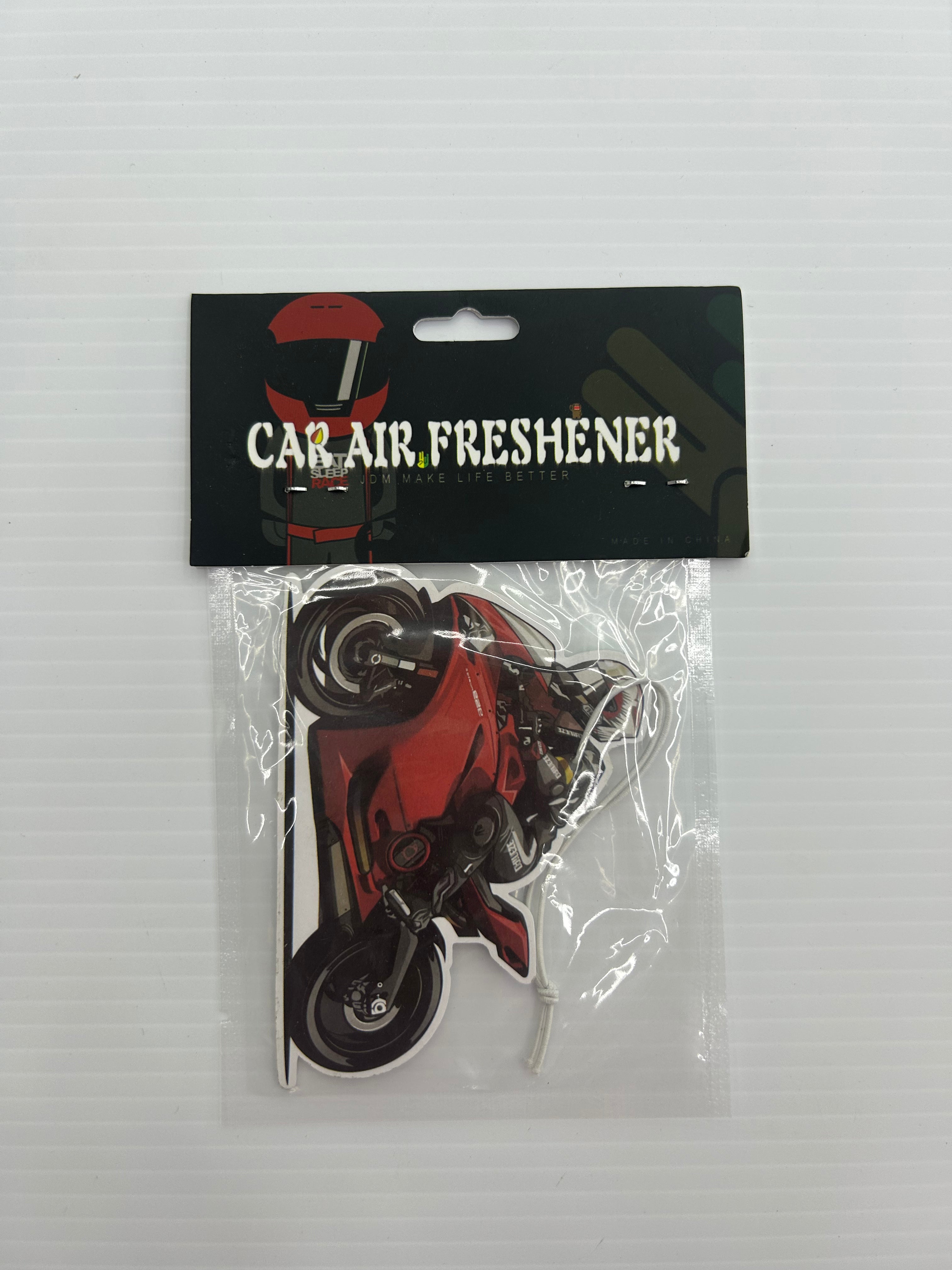 car air freshener featuring a dynamic illustration of a red high-performance motorcycle